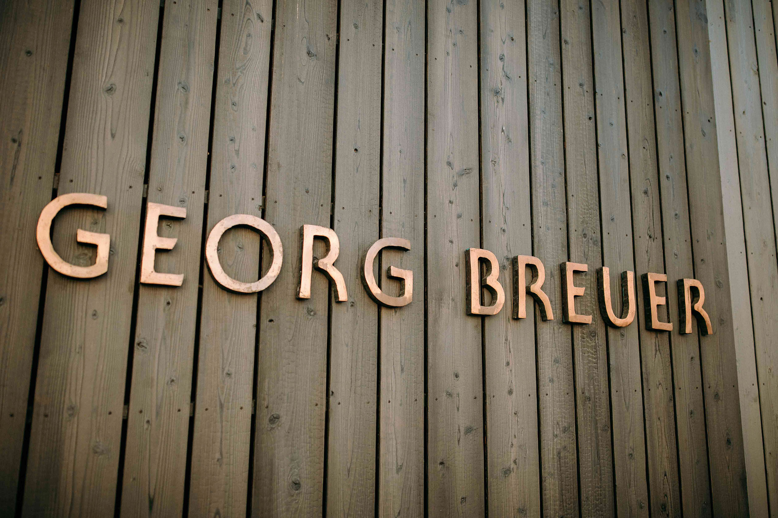 Eingang mit Holzfassade und Georg Breuer Schriftzug – Hochzeitslocation Weingut Georg Breuer