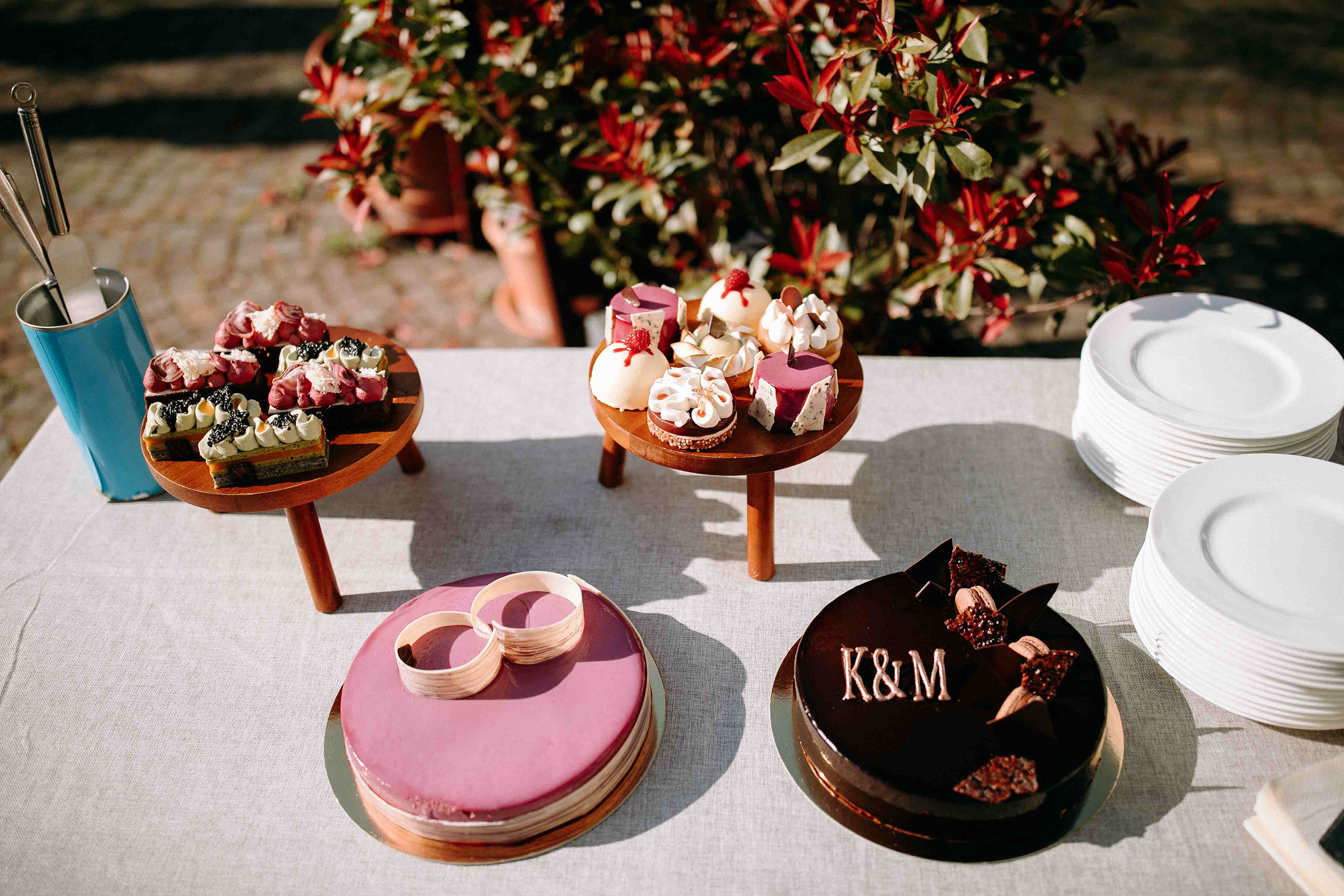 Eine kunstvoll angerichtete Auswahl an Hochzeitstorten und Desserts auf einem Tisch in der Hochzeitslocation Schloss Reinhartshausen – festgehal
